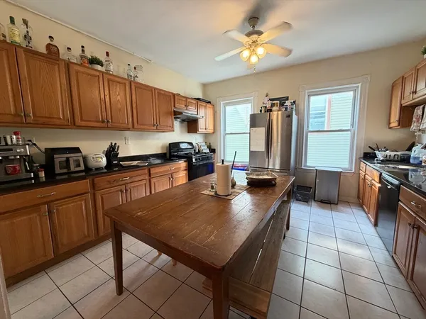 a kitchen with a sink a counter top space appliances and cabinets