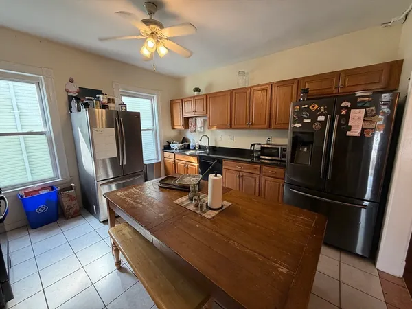 a kitchen with stainless steel appliances granite countertop a refrigerator stove top oven and sink