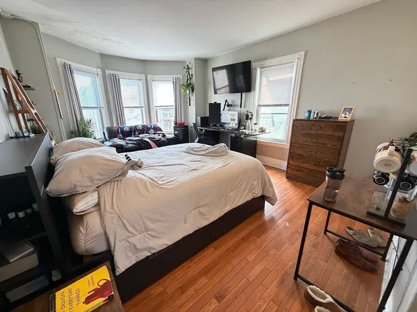 a bed room with a bed window and a chair