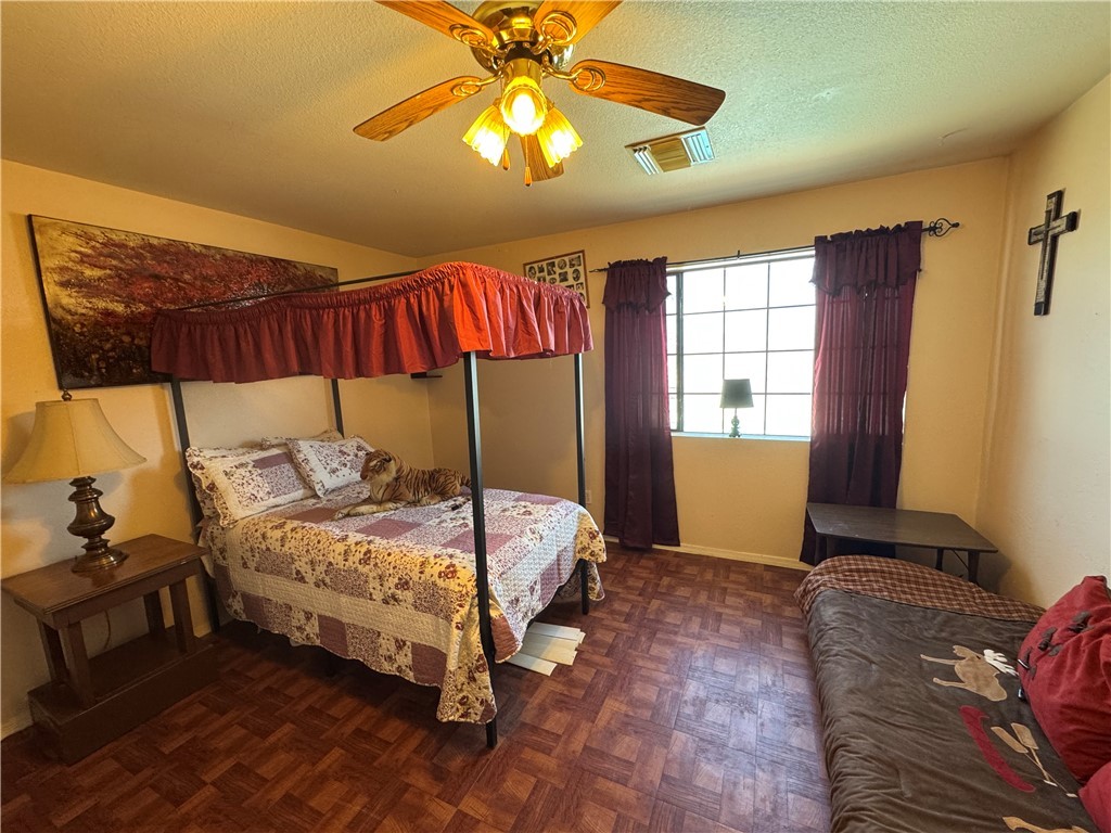 1692 South Verde Road Golden Valley, AZ 86413 - Photo 23 of 39 Bedroom with a ceiling fan and a textured ceiling