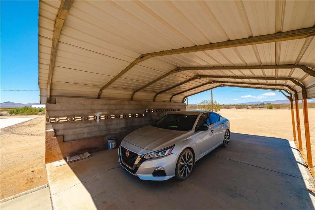 1692 South Verde Road Golden Valley, AZ 86413 - Photo 29 of 39 View of parking / parking lot featuring a detached carport and a mountain view