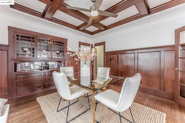 a dining room with furniture a chandelier and wooden floor
