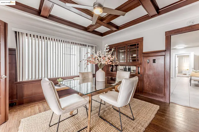 a dining room with furniture and wooden floor