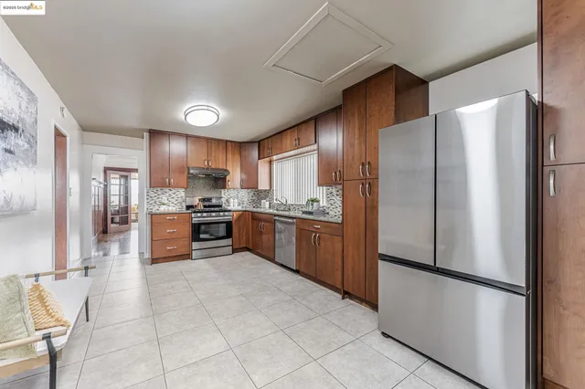 a kitchen with stainless steel appliances a refrigerator and a stove