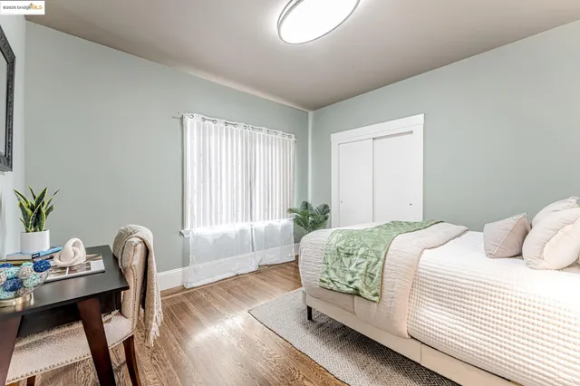 a bedroom with a bed and a large window