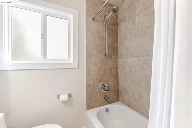 a bathroom with a tub shower and a sink