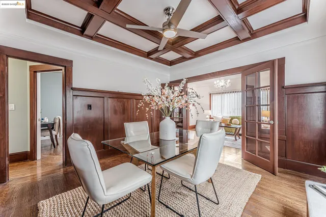 a dining room with furniture a chandelier and wooden floor