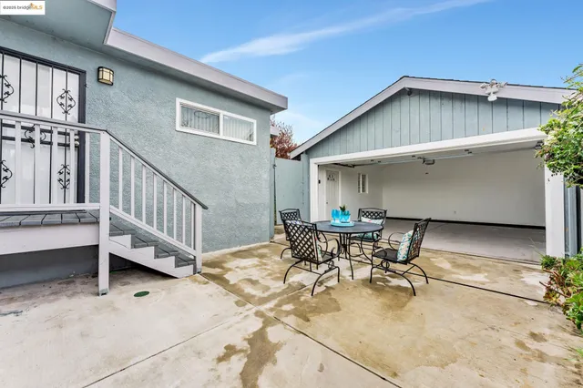 a patio with table and chairs