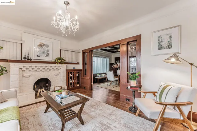 a living room with furniture and a chandelier