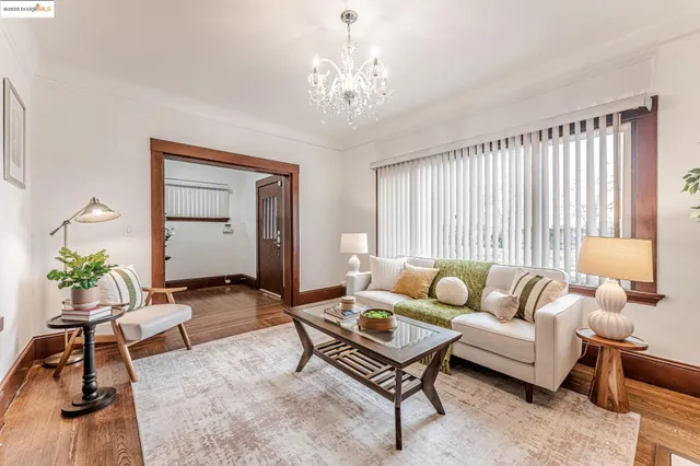 a living room with furniture and a chandelier