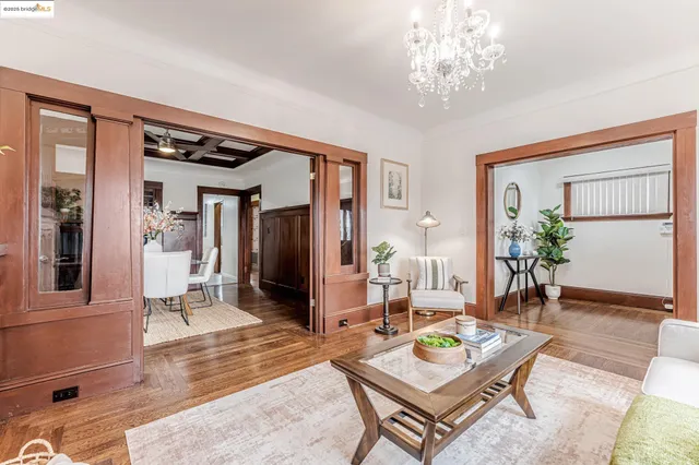 a living room with furniture and a chandelier