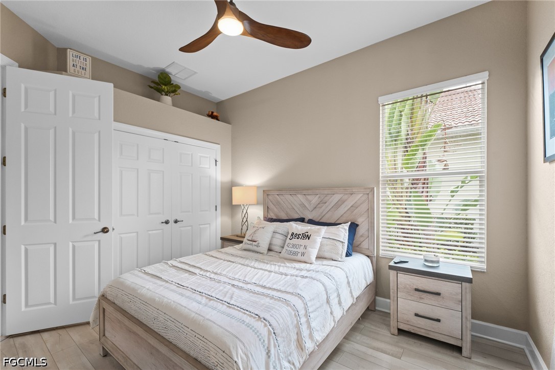 9042 Bronco Court Naples, FL 34113 - Photo 26 of 50 a bedroom with a bed and a window