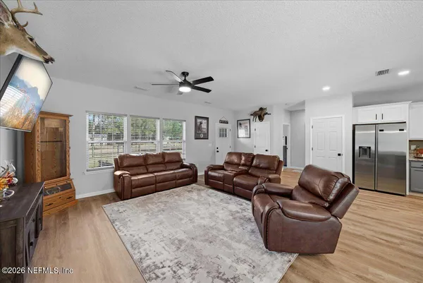 a living room with furniture a couch and a flat screen tv