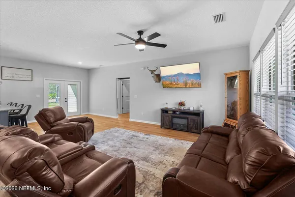 a living room with furniture and wooden floor