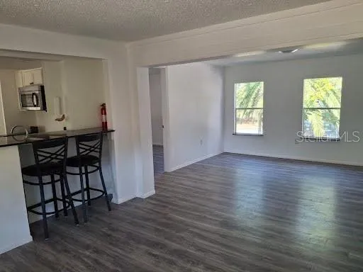 a view of a livingroom with furniture window and wooden floor