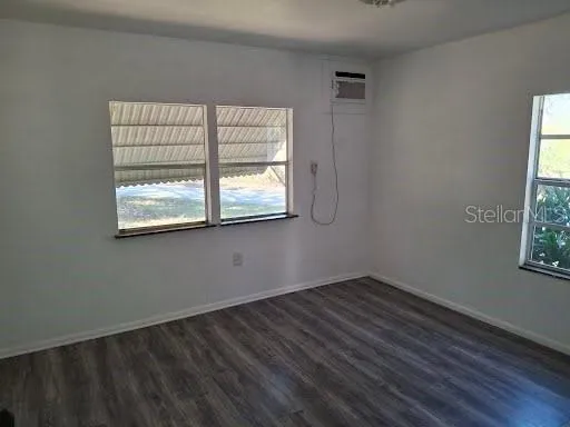 a view of an empty room with wooden floor