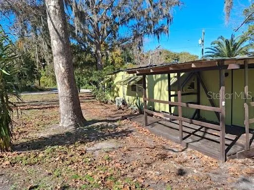 a view of house with backyard and outdoor seating