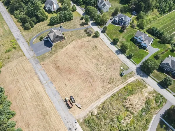 an aerial view of a house with a yard
