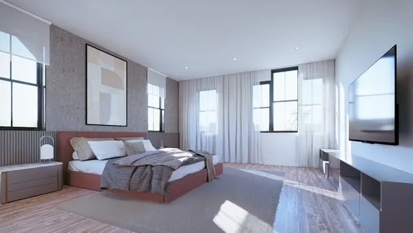 a bedroom with furniture and a flat screen tv