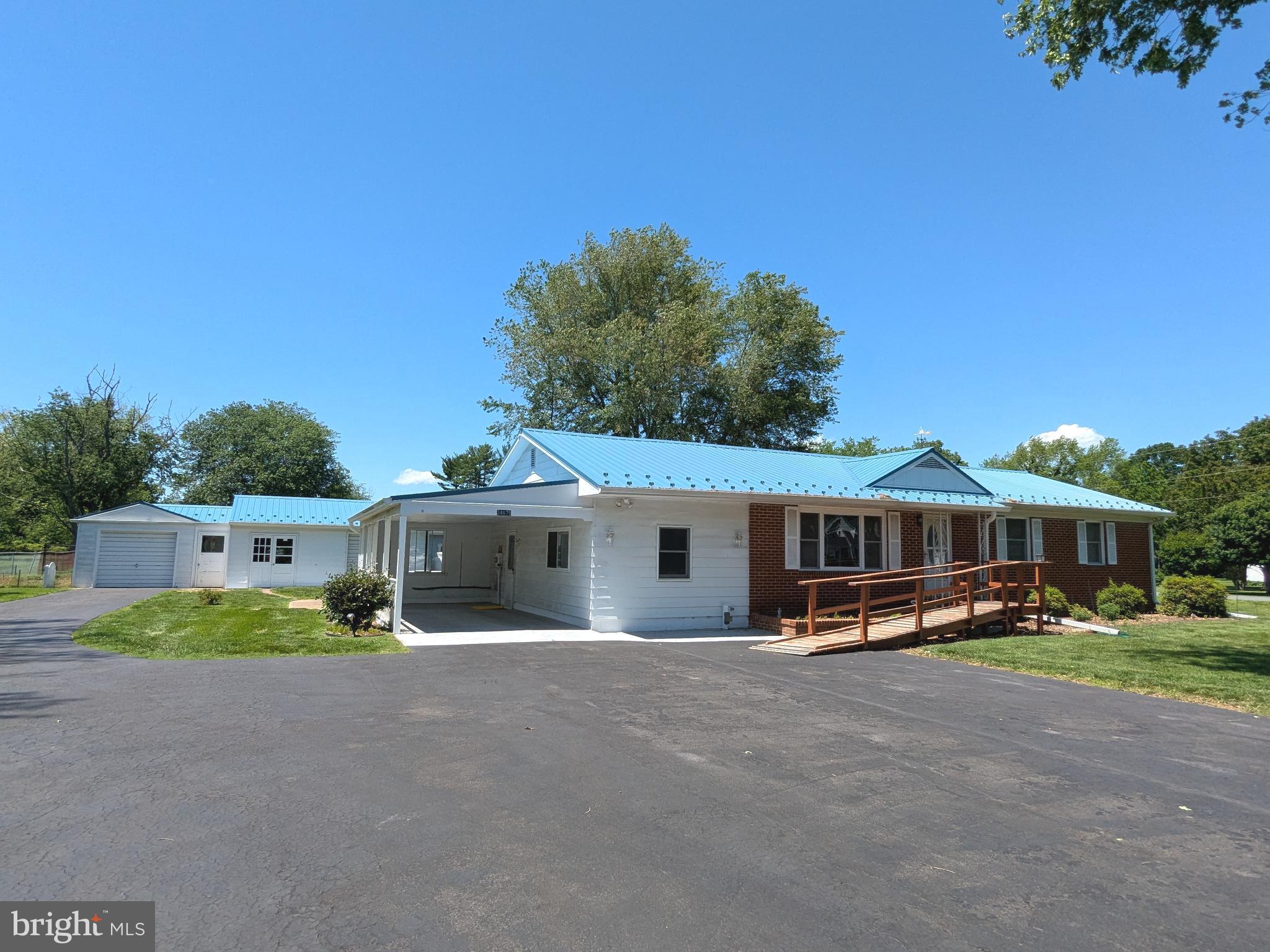 24675 Blackistone Road Hollywood, MD 20636 - Photo 18 of 27 a view of a white house with a big yard and potted plants