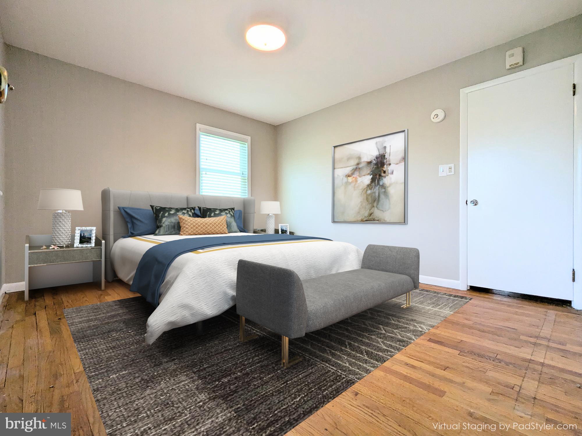 24675 Blackistone Road Hollywood, MD 20636 - Photo 24 of 27 a bedroom with a bed lamp and a window