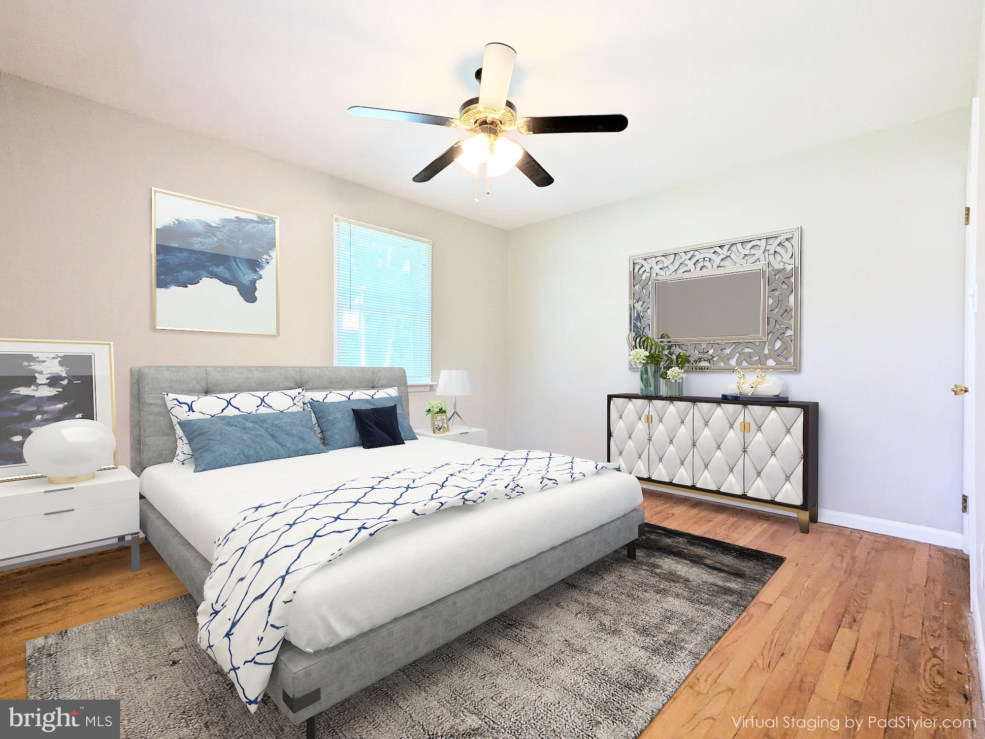 24675 Blackistone Road Hollywood, MD 20636 - Photo 8 of 27 a bedroom with a large bed and a chandelier