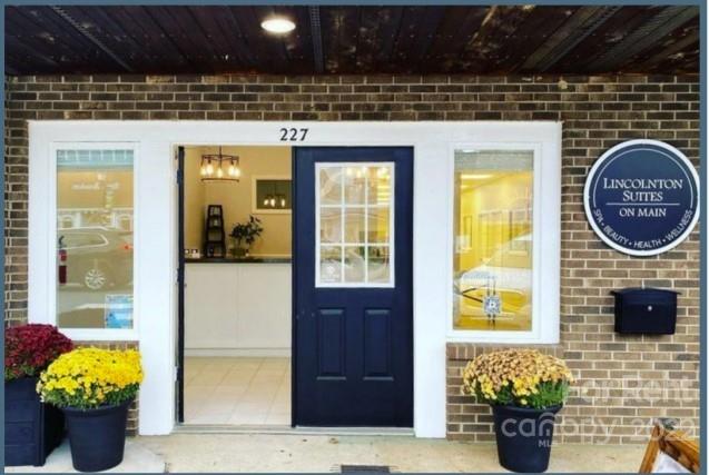 227 East Main Street, Unit SUITE F Lincolnton, NC 28092 - Photo 1 of 4 a front view of a house with outdoor seating