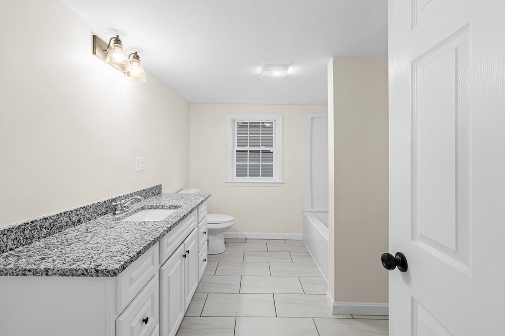 12 Sylvan Road Norton, MA 02766 - Photo 20 of 39 a spacious bathroom with a granite countertop sink and a vanity