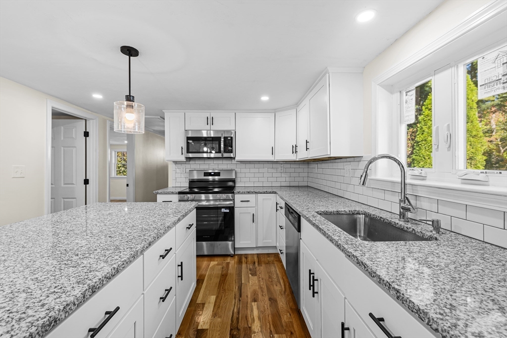 12 Sylvan Road Norton, MA 02766 - Photo 2 of 39 a kitchen with kitchen island granite countertop a sink stainless steel appliances and window