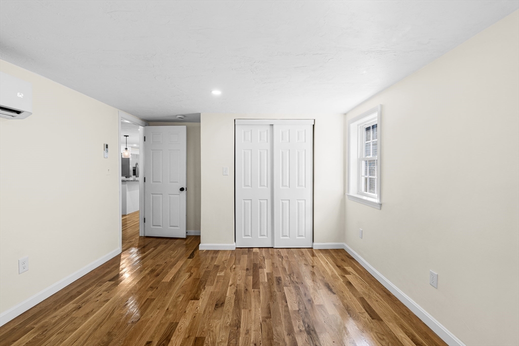 12 Sylvan Road Norton, MA 02766 - Photo 24 of 39 an empty room with wooden floor and windows