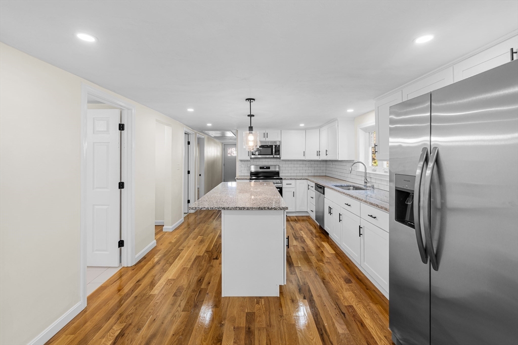 12 Sylvan Road Norton, MA 02766 - Photo 4 of 39 a kitchen with refrigerator a stove and cabinets