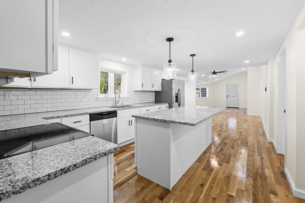 12 Sylvan Road Norton, MA 02766 - Photo 5 of 39 a kitchen with stainless steel appliances granite countertop a sink stove and cabinets
