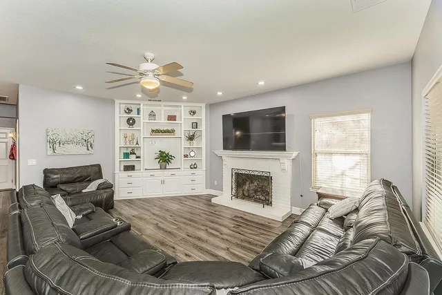 a large white kitchen with stainless steel appliances kitchen island granite countertop a sink and cabinets