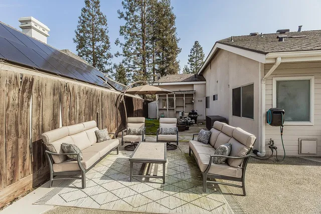 a outdoor space with patio the couches and a dining table with the view of the house