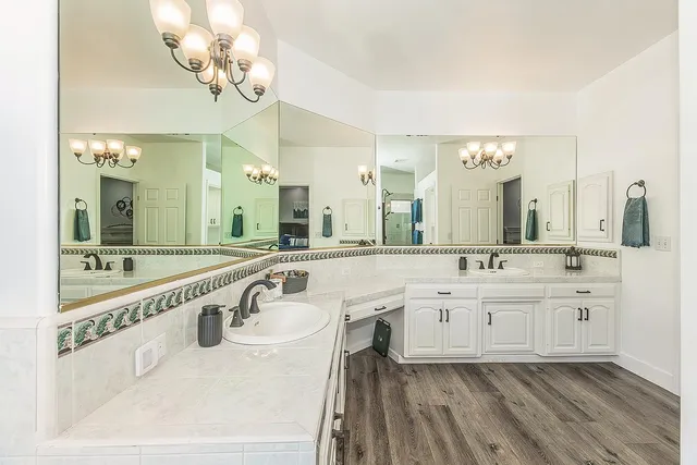 a spacious bathroom with a granite countertop sink mirror and