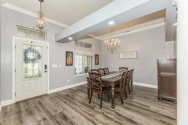 a view of a dining room with furniture and wooden floor
