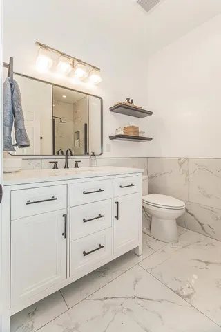 a view of a house with a small yard and wooden fence