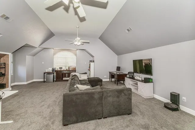 a view of a park with plants and wooden fence