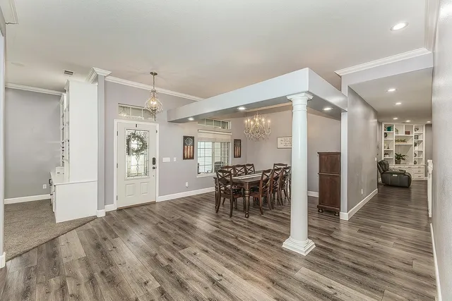 a dining room with furniture and wooden floor