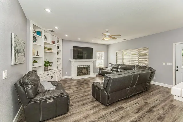 a living room with furniture fireplace and a flat screen tv