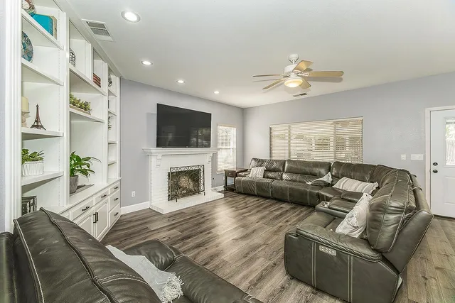 a living room with furniture fireplace and a flat screen tv