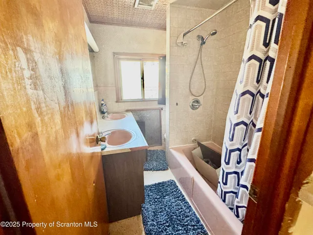 a view of a hallway with furniture and front door