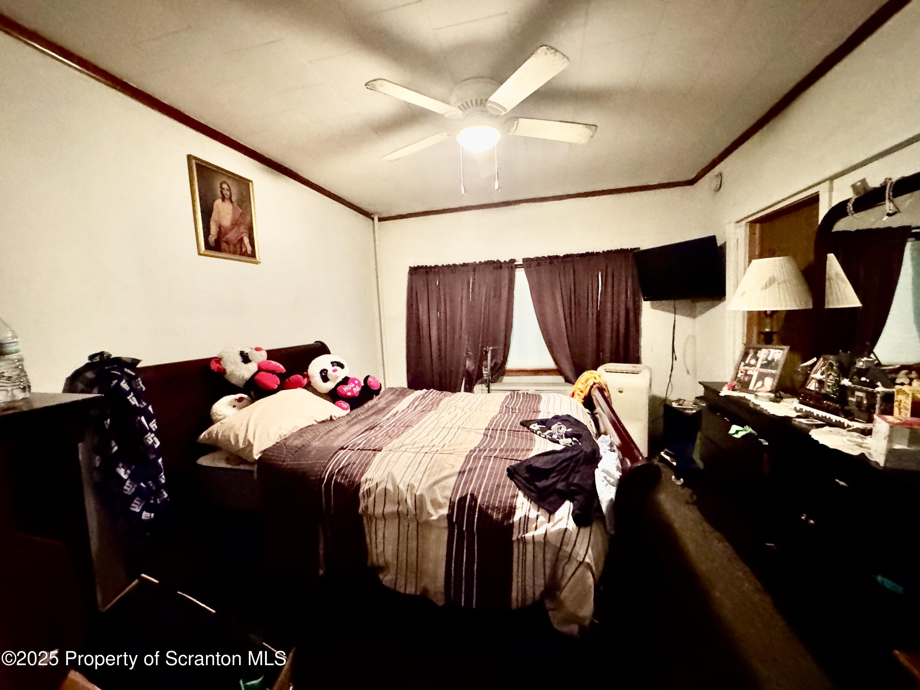 1430 North Main Avenue Scranton, PA 18508 - Photo 19 of 31 a bedroom with a bed and a chandelier