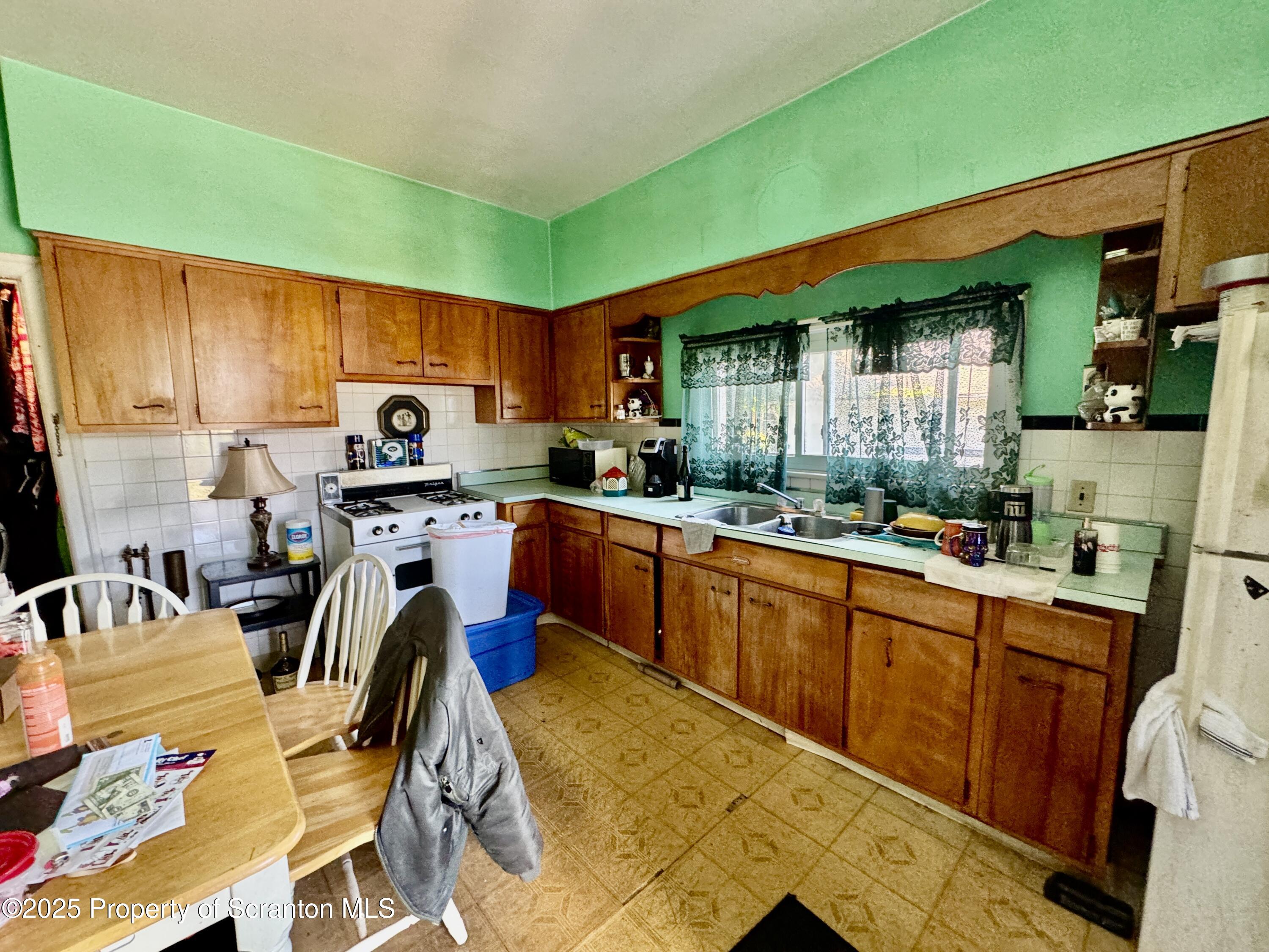 1430 North Main Avenue Scranton, PA 18508 - Photo 21 of 31 a kitchen with stainless steel appliances kitchen island granite countertop a sink and cabinets