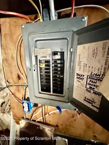 a view of a dining room with furniture and a chandelier