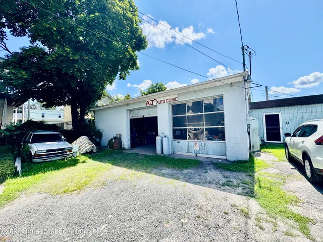 a view of a house with couches yard fire pit and a yard