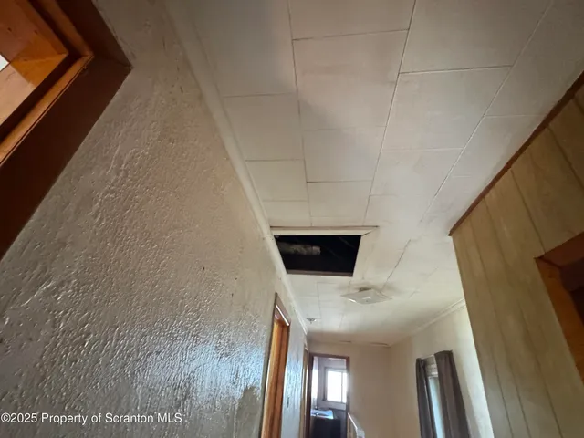 a kitchen with sink a refrigerator and wooden floor