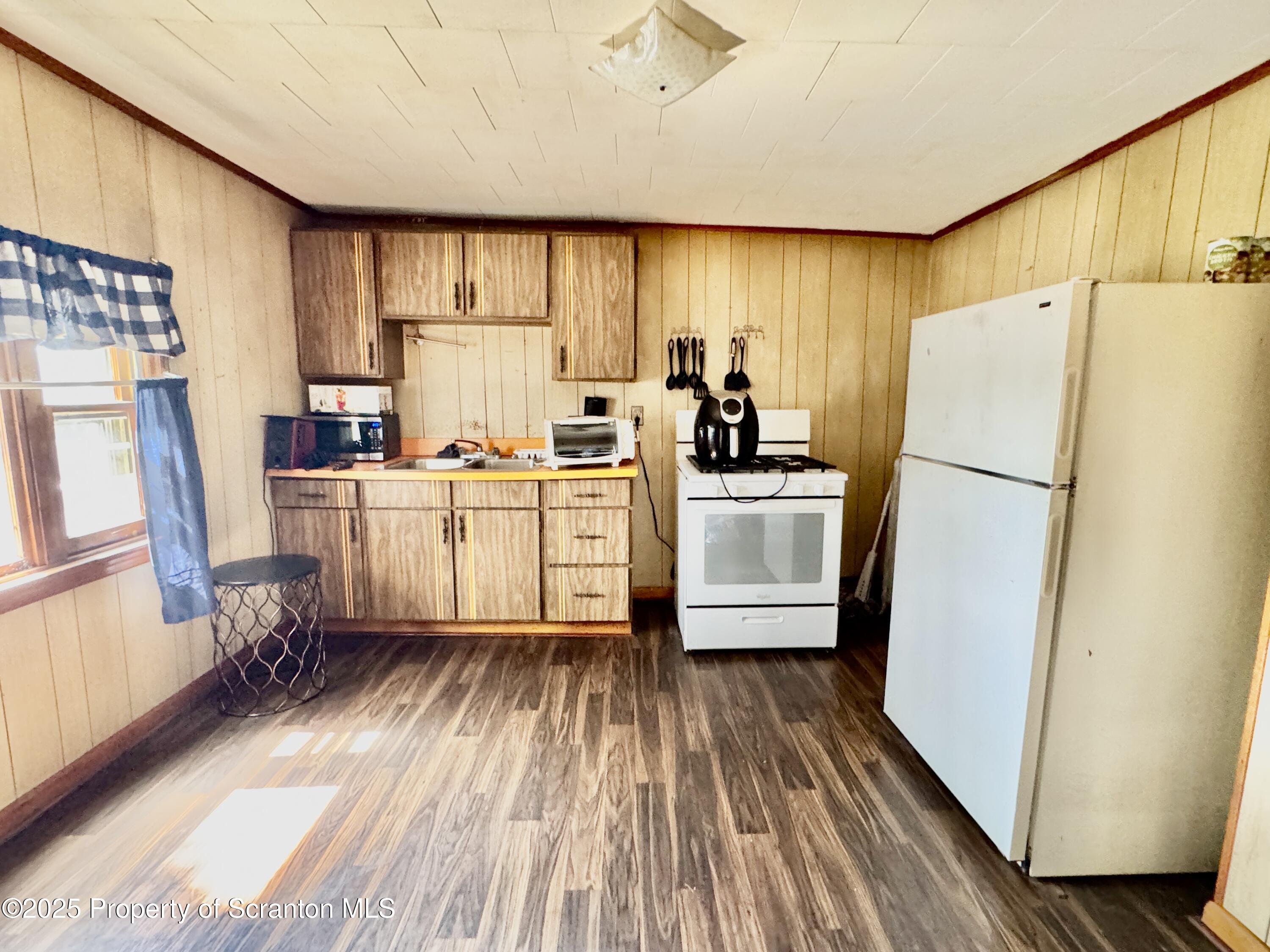 1430 North Main Avenue Scranton, PA 18508 - Photo 10 of 31 a kitchen with sink a refrigerator and wooden floor