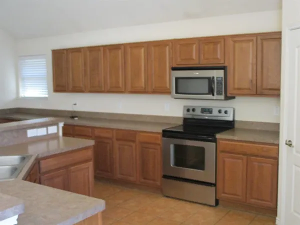 a kitchen with a sink stove and microwave