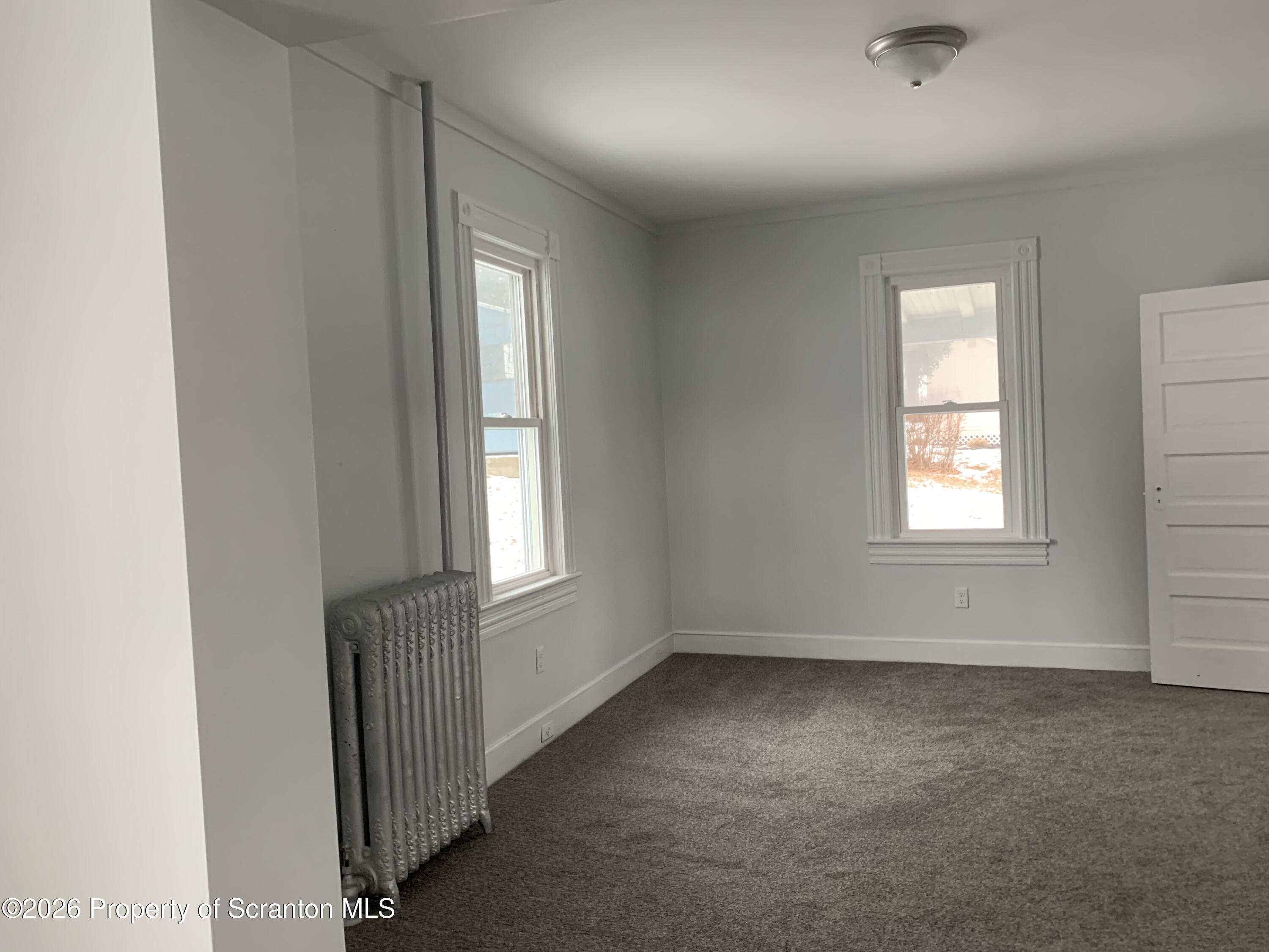 709 Meade Street Dunmore, PA 18512 - Photo 17 of 38 an empty room with windows